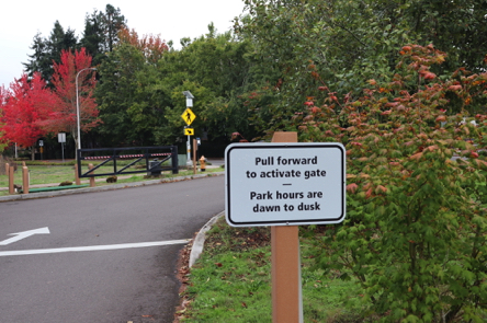 Sign: Pull forward to activate gate – park hours dawn to dusk